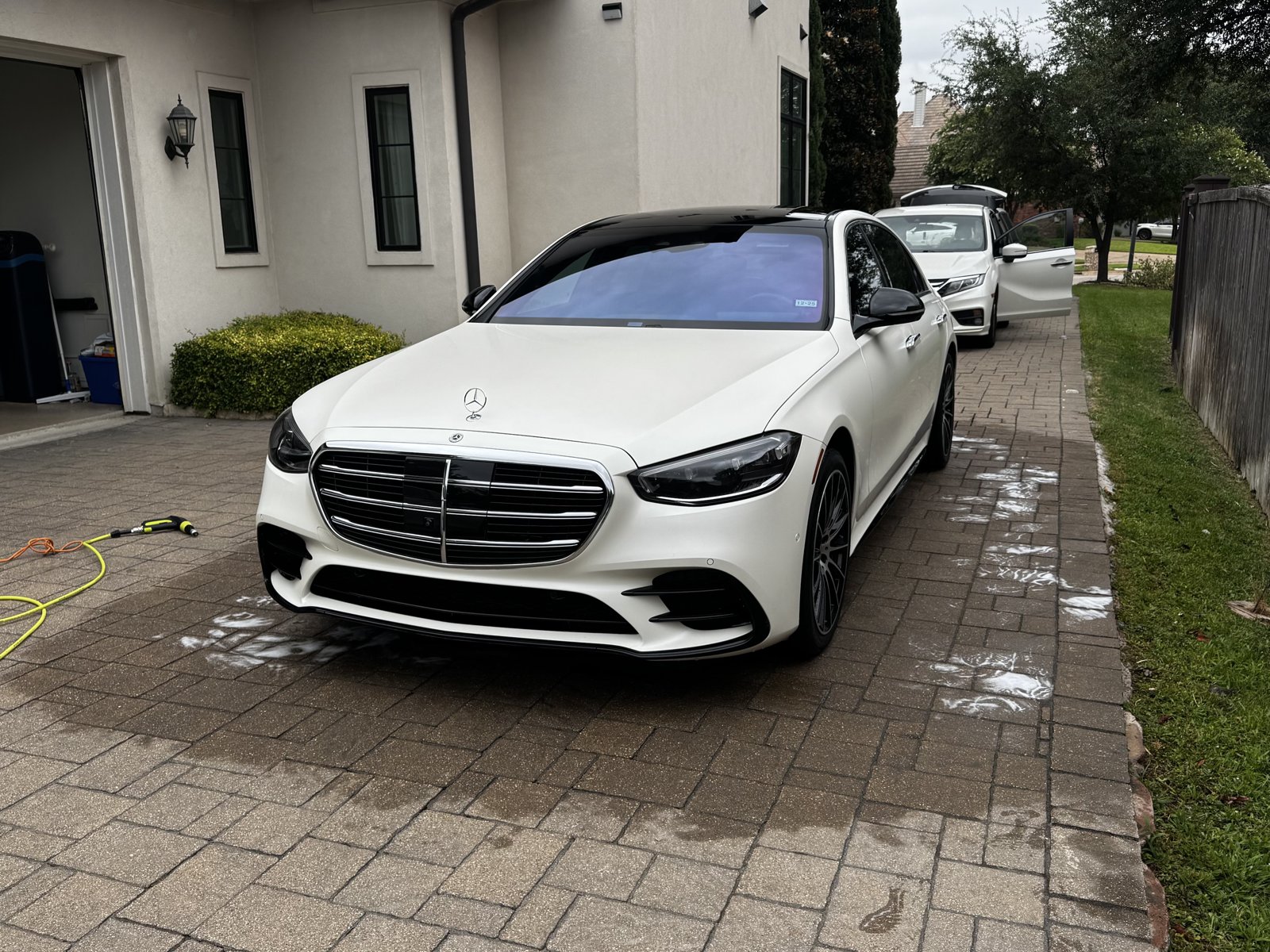 White Mercedes-Benz S-Class sedan being detailed in a driveway